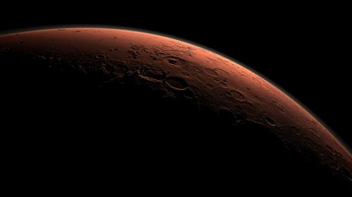 Litt av planeten mars mot den mørke bakgrunnen i universet.